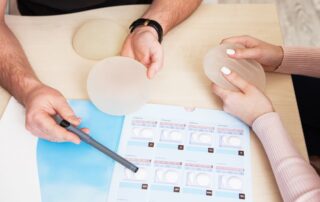 A plastic surgeon doctor shows a sample set of a silicone implants for breast augmentation