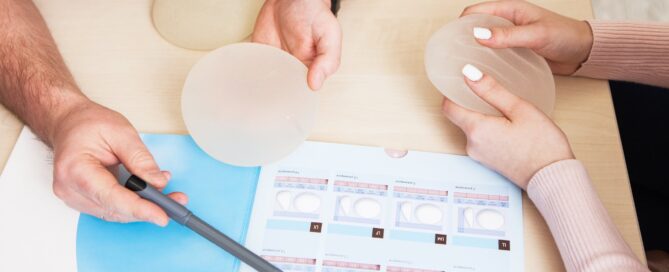 A plastic surgeon doctor shows a sample set of a silicone implants for breast augmentation